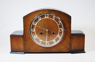 Lot 123 - A 1950s oak cased mantel clock, having raised...