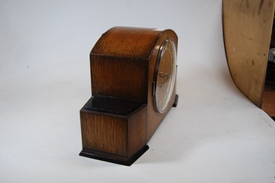Lot 123 - A 1950s oak cased mantel clock, having raised...