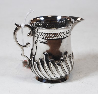 Lot 213 - A silver cream jug, having wrythen decoration...