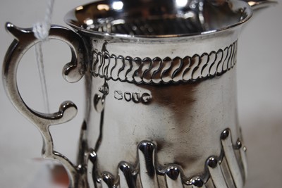 Lot 213 - A silver cream jug, having wrythen decoration...