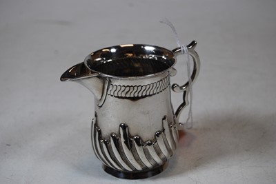 Lot 213 - A silver cream jug, having wrythen decoration...
