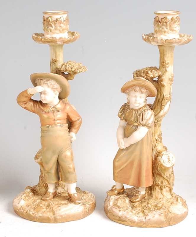 Lot 1027 - A pair of Hadley Worcester porcelain boy and...