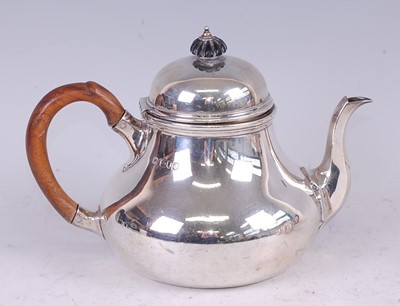 Lot 1115 - A late Victorian silver teapot, in the early...