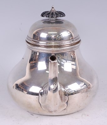 Lot 1115 - A late Victorian silver teapot, in the early...