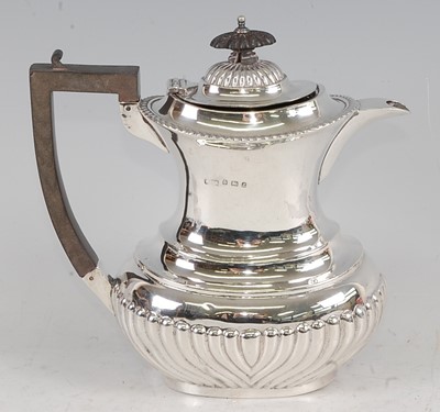 Lot 1119 - An Edwardian silver hot water pot, of...