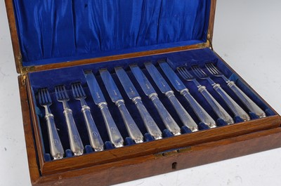 Lot 1125 - A cased 12-place setting of George V silver...
