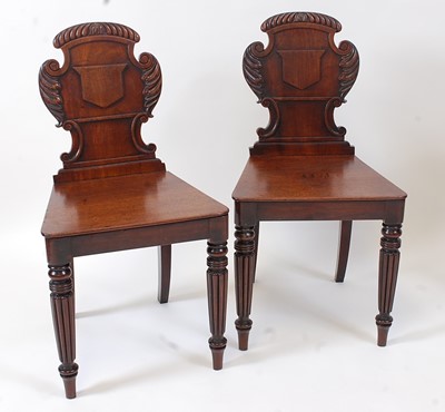 Lot 1472 - A pair of Regency mahogany hall chairs in the...