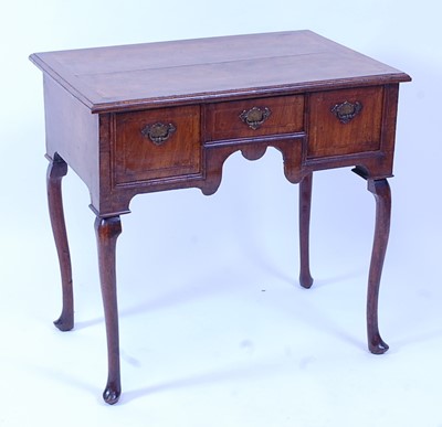 Lot 1429 - A George II walnut lowboy, having a four...