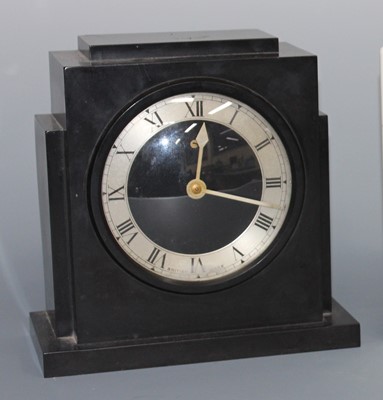 Lot 165 - An Art Deco bakelite mantel clock, the case of...