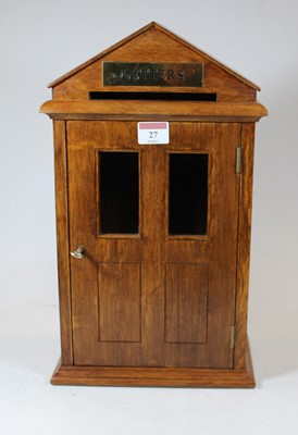 Lot 27 - A 20th century oak letter-box in the form of a...