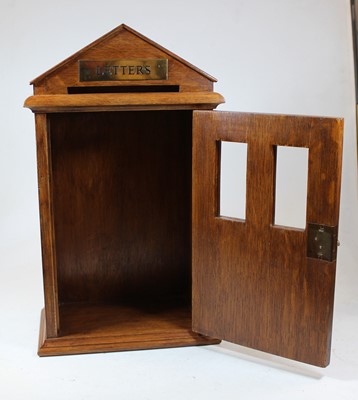 Lot 36 - A 20th century oak letter-box in the form of a...