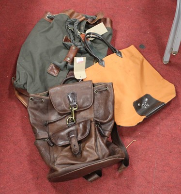 Lot 142 - A canvas and leather clad Timberland bag;...