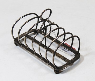 Lot 229 - A George V silver six division toast rack on...