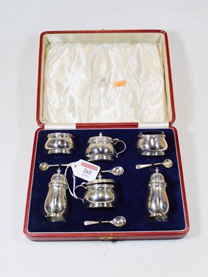 Lot 265 - A George V silver six piece cruet set to...