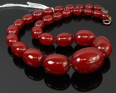 Lot 275 - A beaded and graduated cherry amber necklace,...