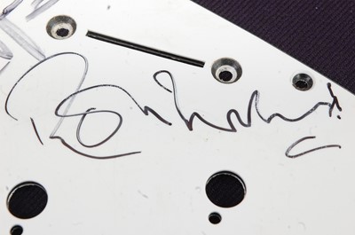 Lot 556 - A guitar scratch plate bearing the signatures...