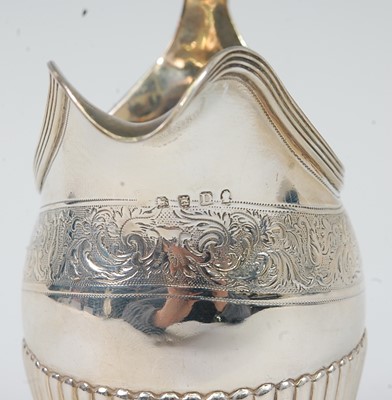 Lot 1162 - A George III silver cream jug, of half-reeded...
