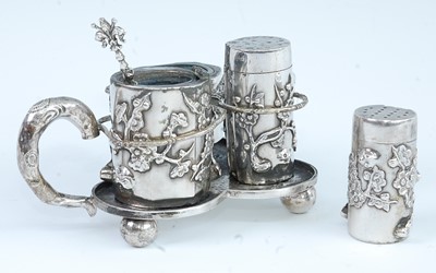 Lot 1298 - A circa 1900 Chinese white metal cruet set, of...