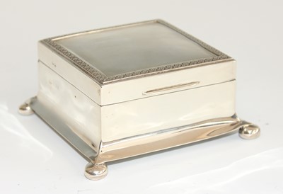 Lot 140 - An Art Deco silver square table cigarette box,...