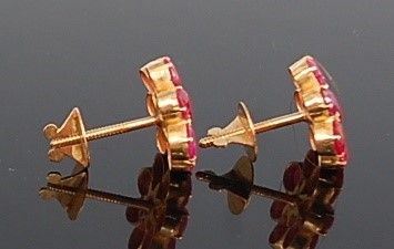 Lot 1188 - A pair of yellow metal ruby flower cluster...