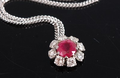 Lot 1189 - A white metal, ruby and diamond daisy shaped...