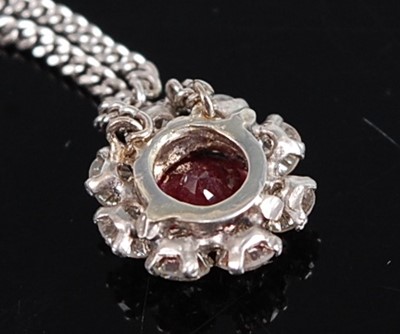 Lot 1189 - A white metal, ruby and diamond daisy shaped...