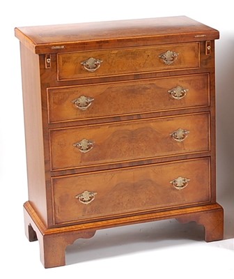 Lot 1381 - A figured walnut bachelors chest, in the early...