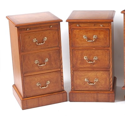 Lot 1441 - A pair of figured walnut three drawer bedside...