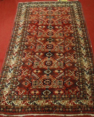 Lot 1370 - A Caucasian woollen rug, the red ground...