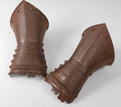 Lot 2363 - A pair of amour gauntlets, of riveted steel...