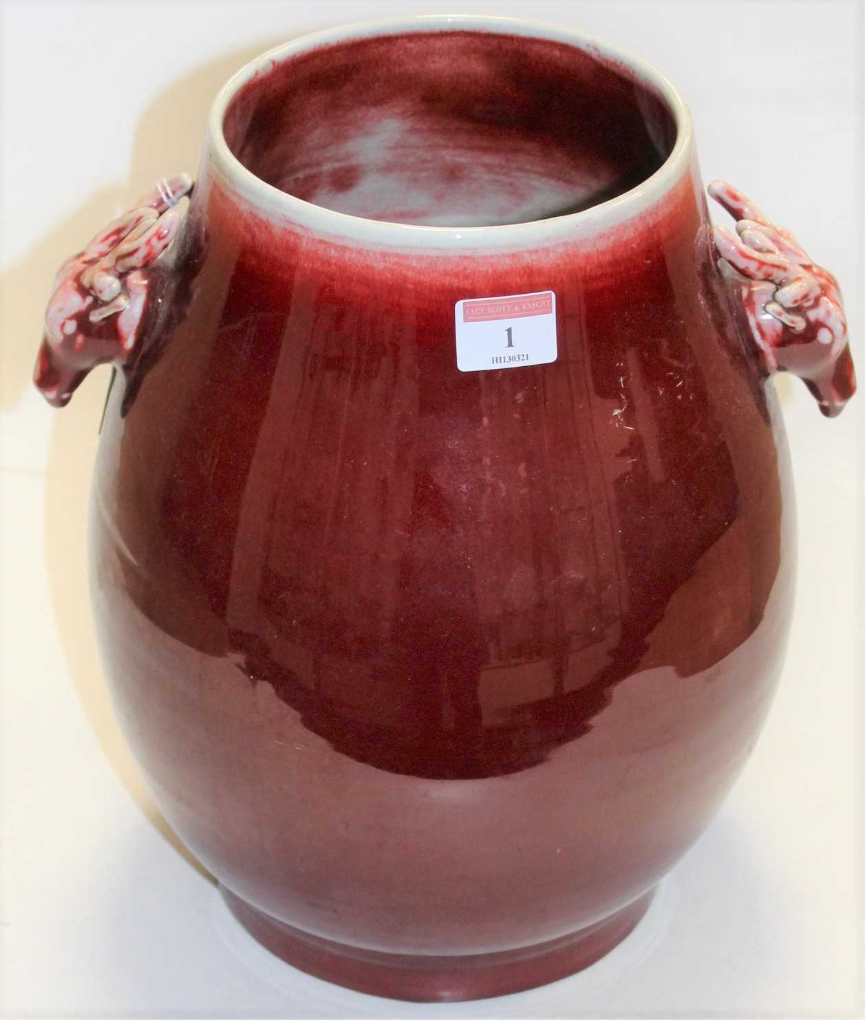 Lot 1 - A large Chinese red flambe glazed stoneware...