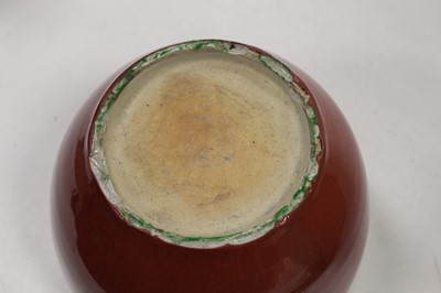 Lot 21 - A Chinese stoneware jardiniere having red...