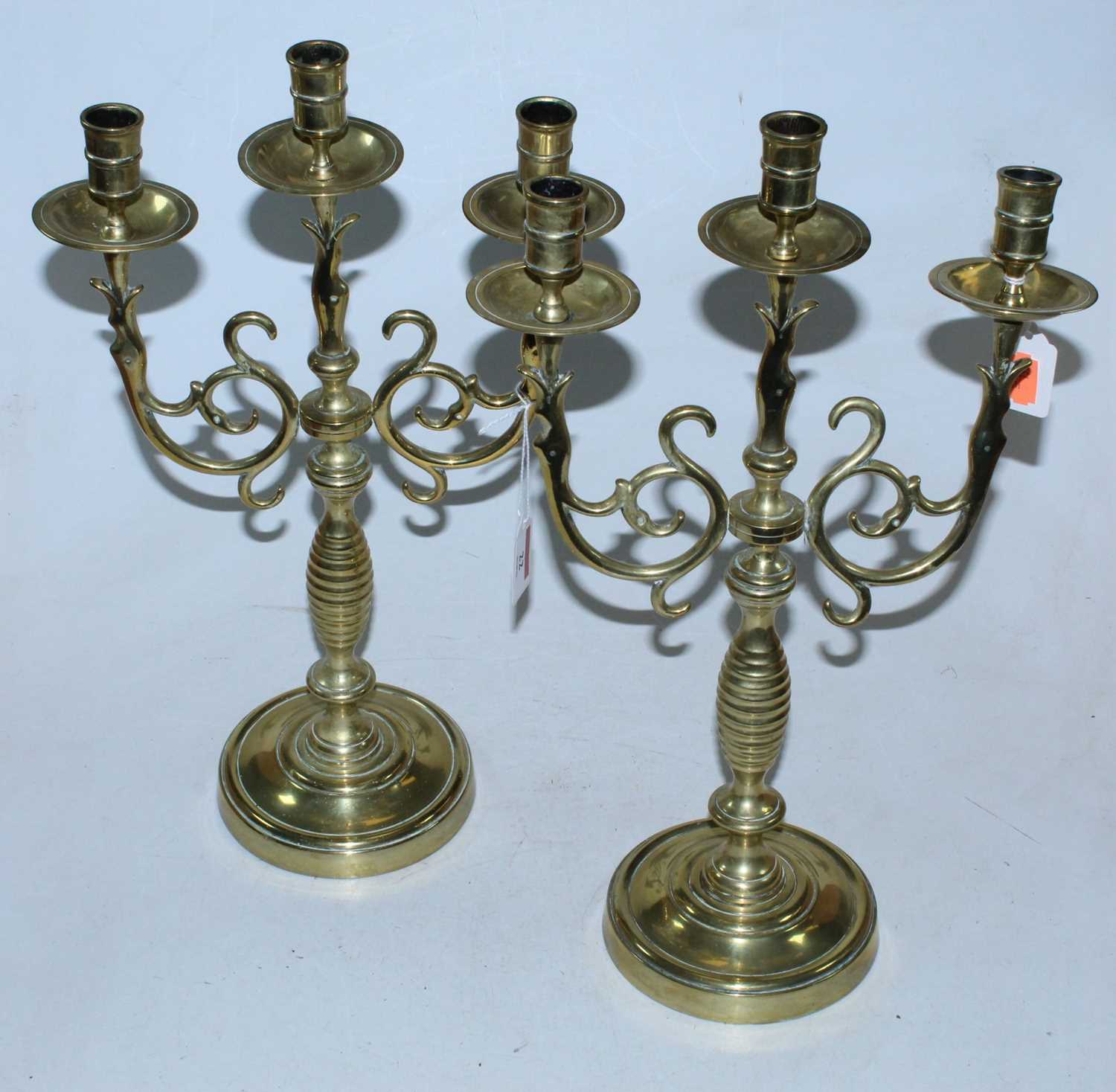 Lot 22 - A pair of turned brass three sconce candelabra,...