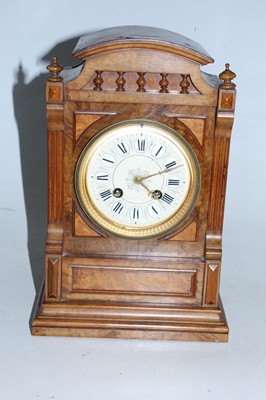 Lot 33 - A late Victorian walnut cased mantel clock of...