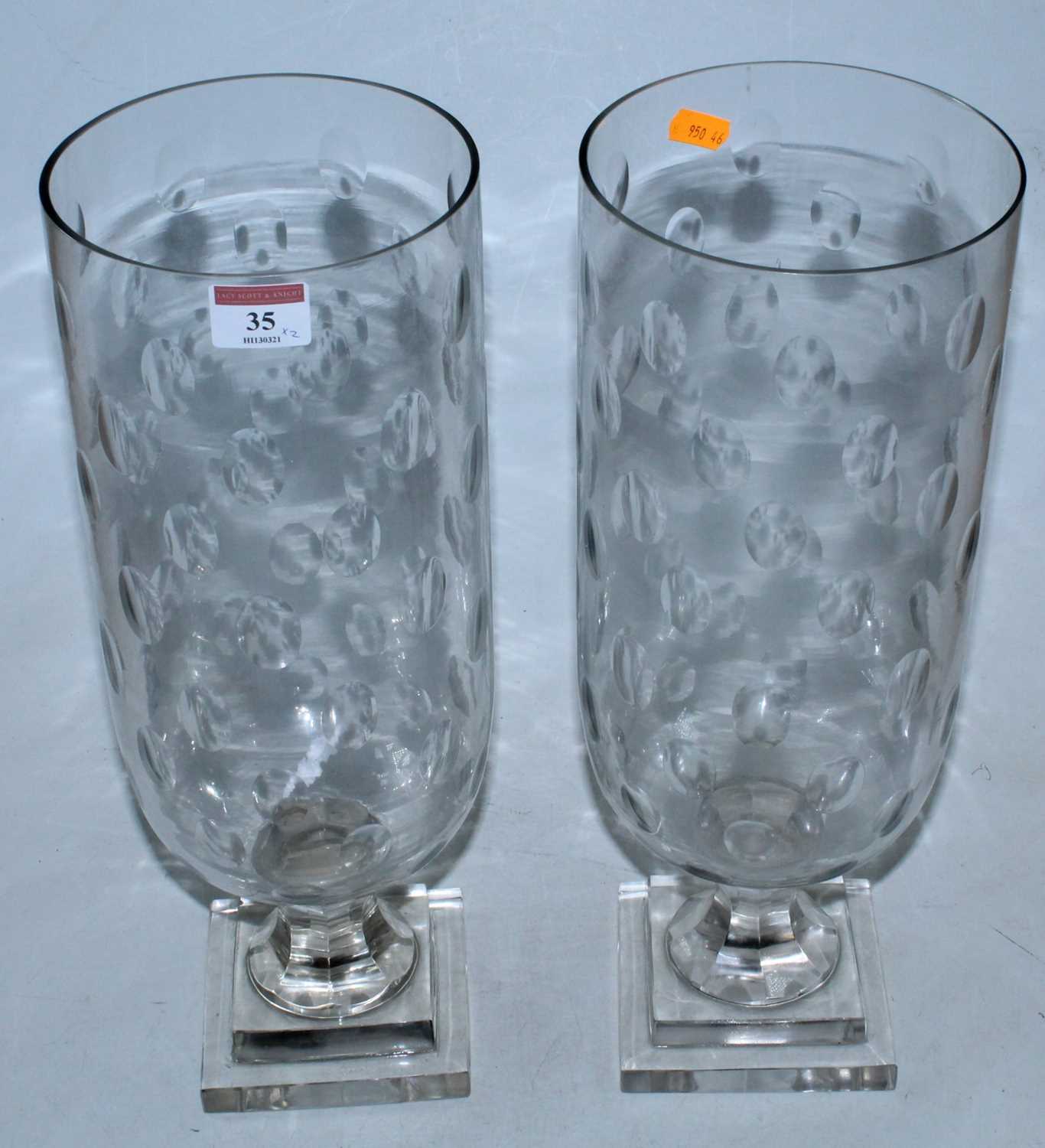 Lot 35 - A pair of large cut glass storm lamps, each of...