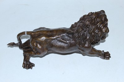 Lot 39 - A reproduction bronzed metal figure of a lion,...