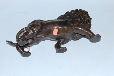 Lot 39 - A reproduction bronzed metal figure of a lion,...