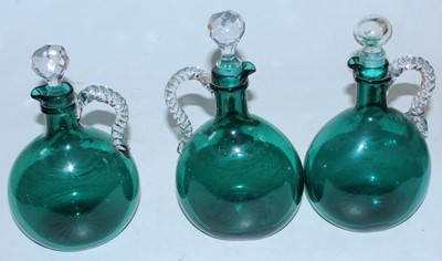 Lot 60 - A set of four Victorian green glass decanters...