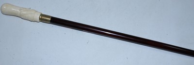 Lot 101 - A walking cane, the bone handle carved in the...