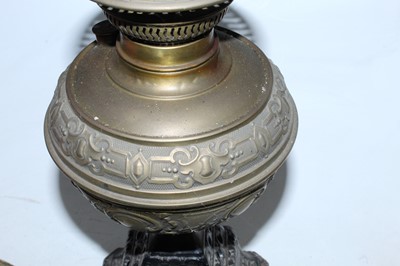 Lot 110 - A Victorian oil lamp having embossed brass...