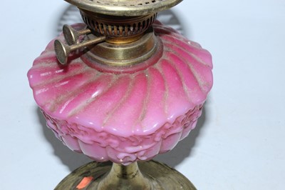 Lot 110 - A Victorian oil lamp having embossed brass...