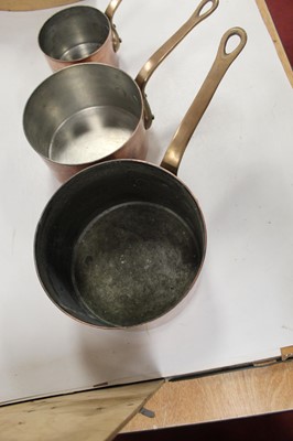 Lot 111 - A graduated set of three copper saucepans and...