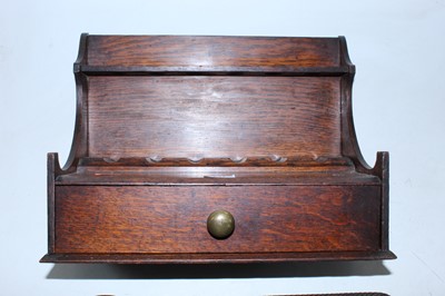 Lot 131 - An Edwardian oak pipe rack with single drawer...