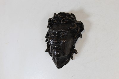 Lot 188 - A modern bronzed metal wall mask in the form...