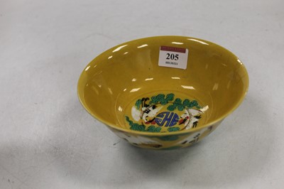 Lot 205 - A Chinese porcelain rice bowl on a yellow...