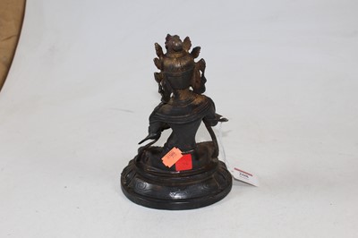 Lot 207 - A Chinese bronzed figure of a deity in typical...