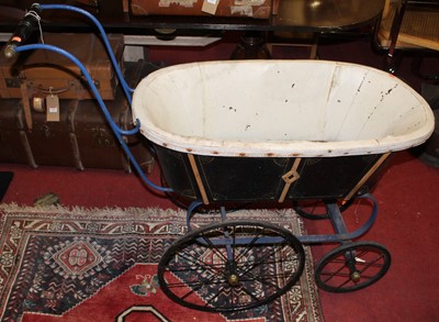 Lot 1467 - A Victorian iron framed pram, having black...