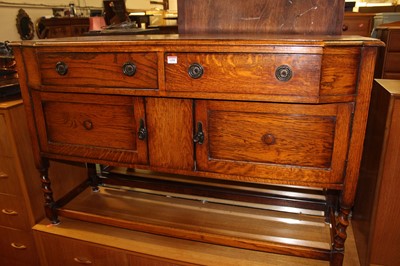 Lot 1458 - A 1920s oak sideboard, having twin frieze...