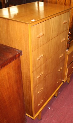 Lot 1460 - A 1960s walnut chest of five long drawers,...