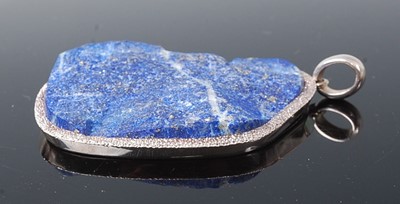 Lot 2621 - A sterling silver lapis lazuli pendant, the...